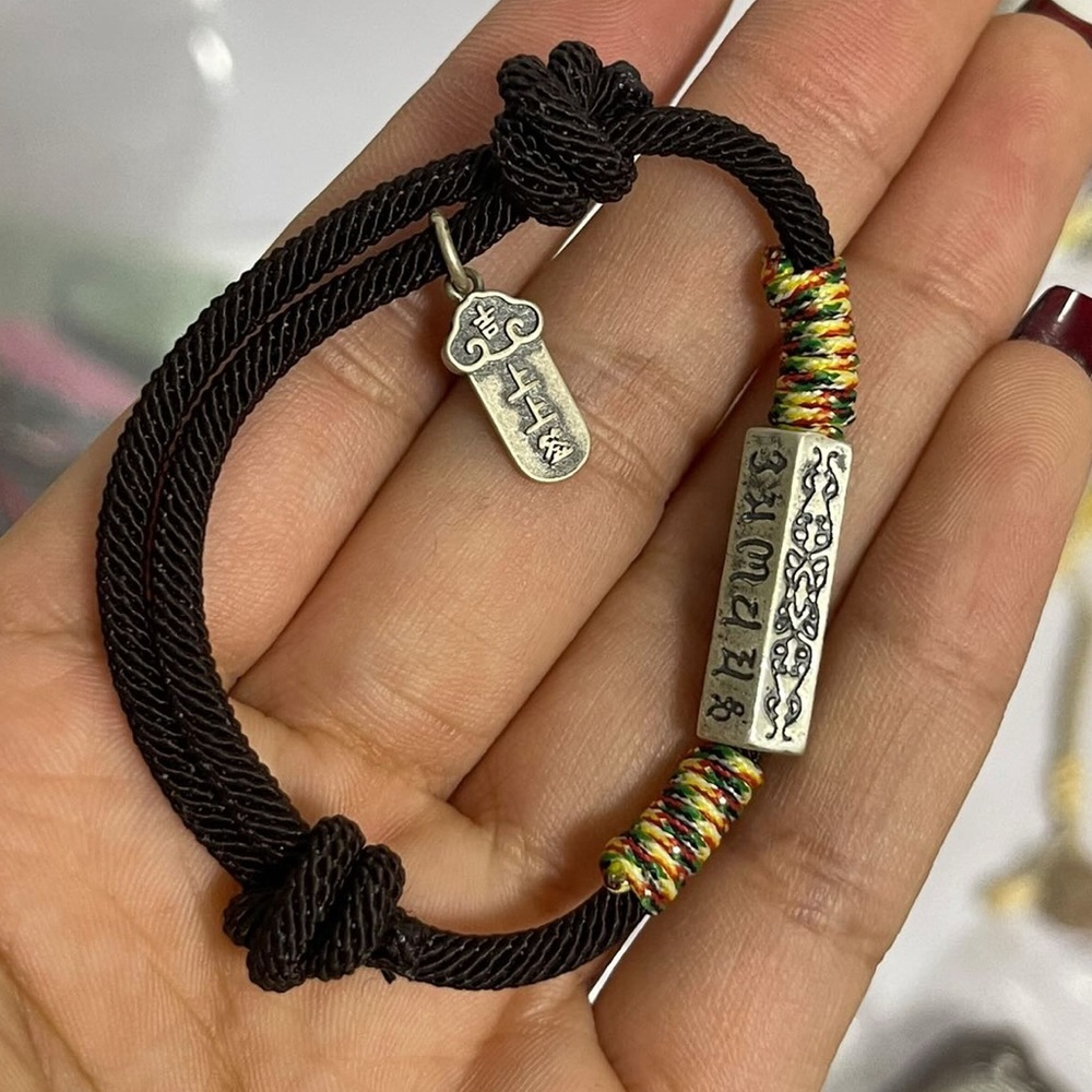 Tibetan blessing .925 bead and charm, on hand-braided adjustable string